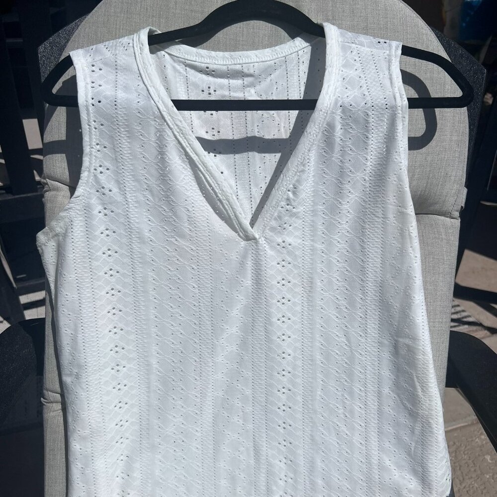 White eyelet style tank top. V neck. NWOT
